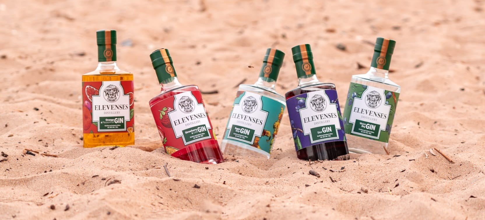 Elevenses Welsh gin bottles on a beach in North Wales