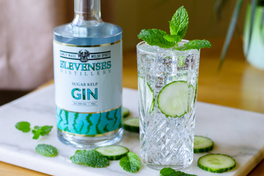 A bottle of Elevenses Sugar Kelp Gin with a refreshing summer cocktail